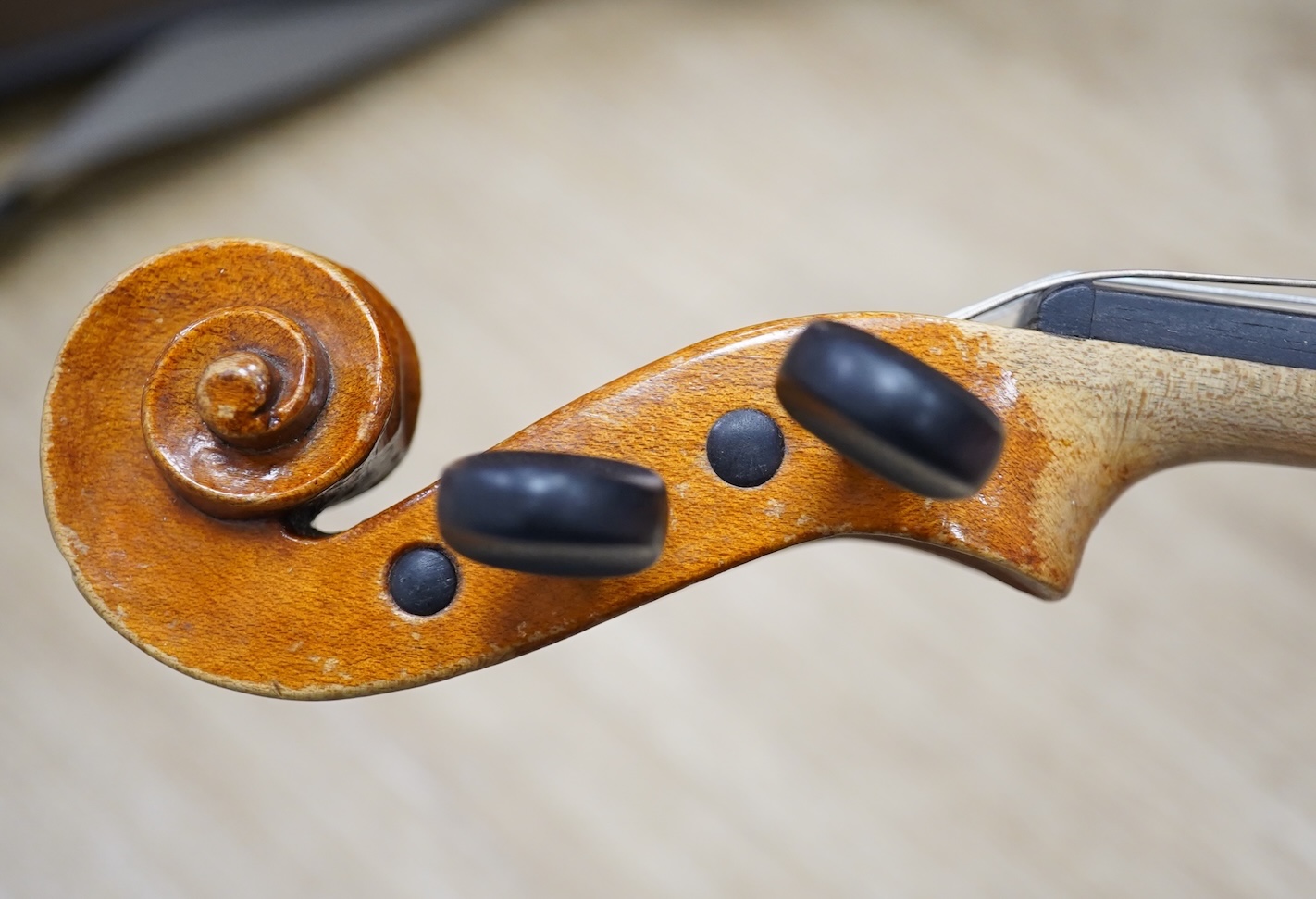 Two cased three quarter size violins, one labelled the London violin Co Ltd, length of back 33.5cm. Condition - both scratched